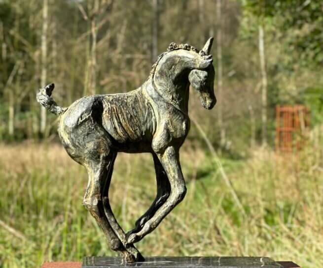 Foal statue bronze playful.